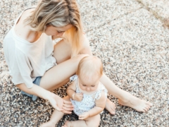 woman and a baby sitting on the ground