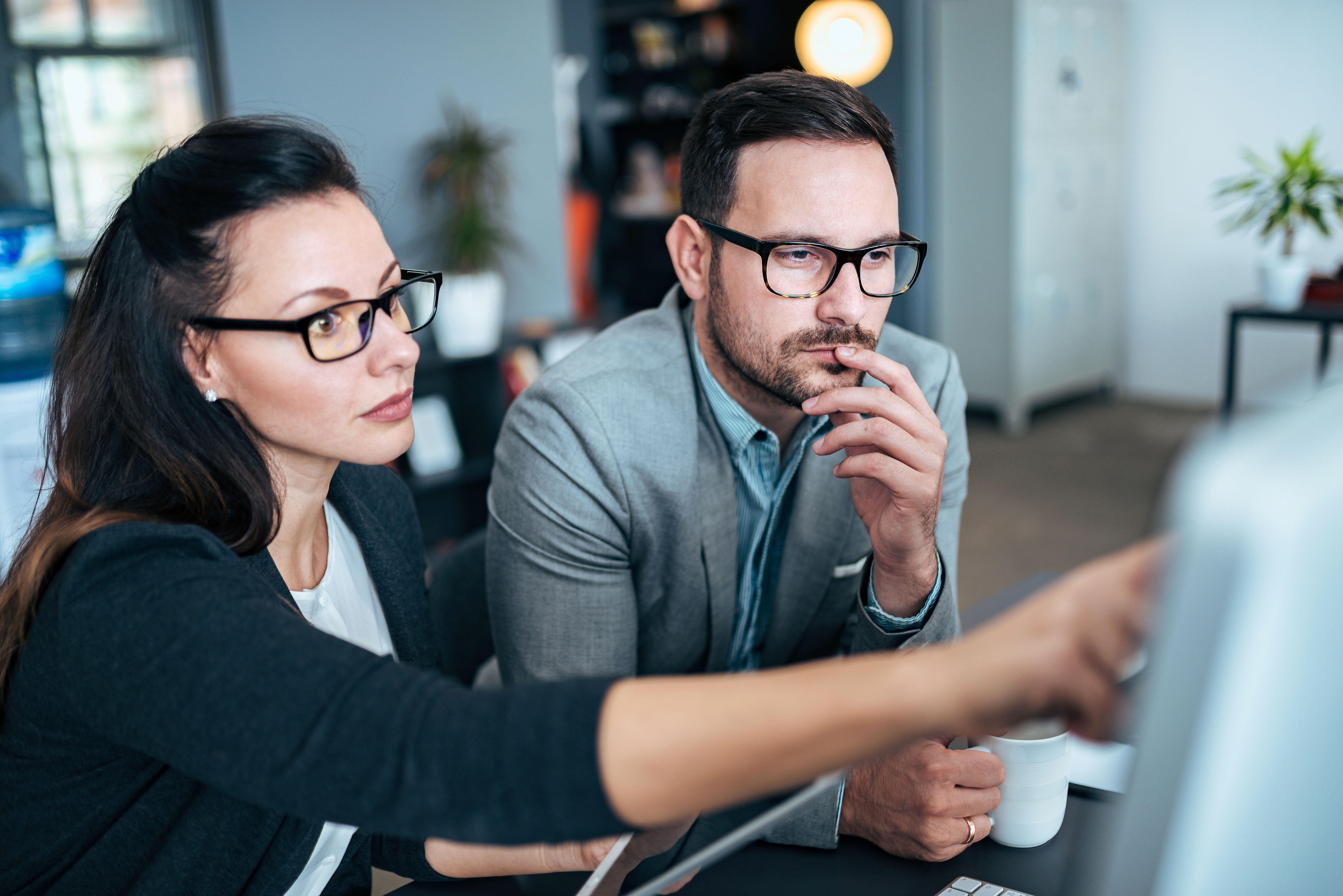 Female and Male in Office at Computer