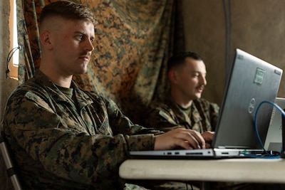 Two Marines monitor the USMC enterprise network for digital threats.