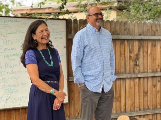 A smiling Secretary Haaland speaks with youth conservation volunteers at La Plazita Institute in Albuquerque, New Mexico