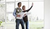 man and woman looking at building plans