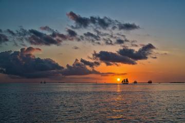 Sailboats on the water at sunset