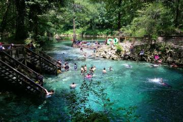 People swimming at the main spring and in the river Madison Blue Spring State Park.