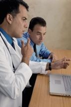 Health care professionals using laptop