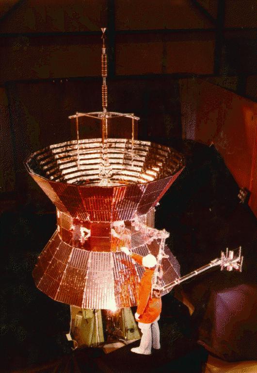 Man and spacecraft in cleanroom.