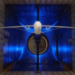 A scale model of truss-braced wing aircraft is suspended within a wind tunnel for testing.