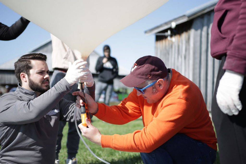 Students filling research balloons.