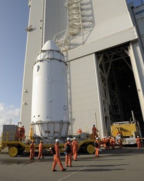 Workers truck the HTV-1 to Vehicle Assembly Building (VAB)