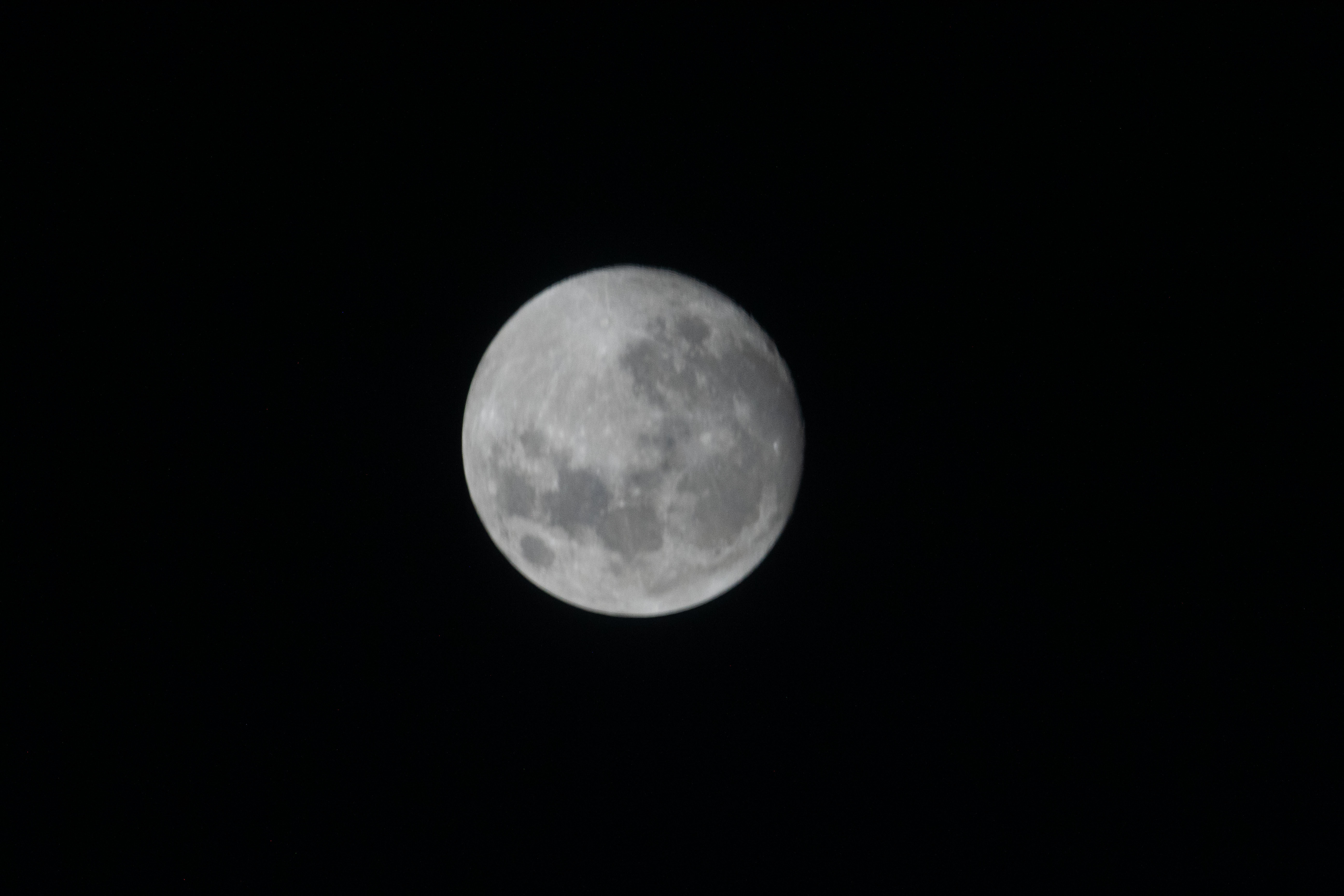 The waxing gibbous Moon looks nearly full in the darkness of space.