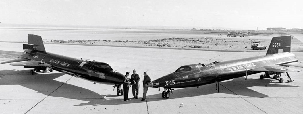 Standing between the first two aircraft, North American Aviation chief test pilot A. Scott Crossfield, left, symbolically hands over the keys to the X-15 to U.S. Air Force pilot Robert M. White and NASA pilot Neil A. Armstrong at the conclusion of the contracted flight test program. Image credit: courtesy North American Aviation. 