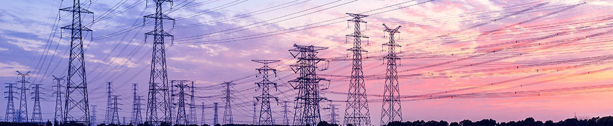 Setting sun background of purples and pinks with power towers and lines