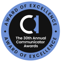 Circle badge. Blue outer ring with black lettering reading Award of Excellence at the top and bottom. Inside is black with a lowercase A and then the words The 30th Annual Communicator Awards