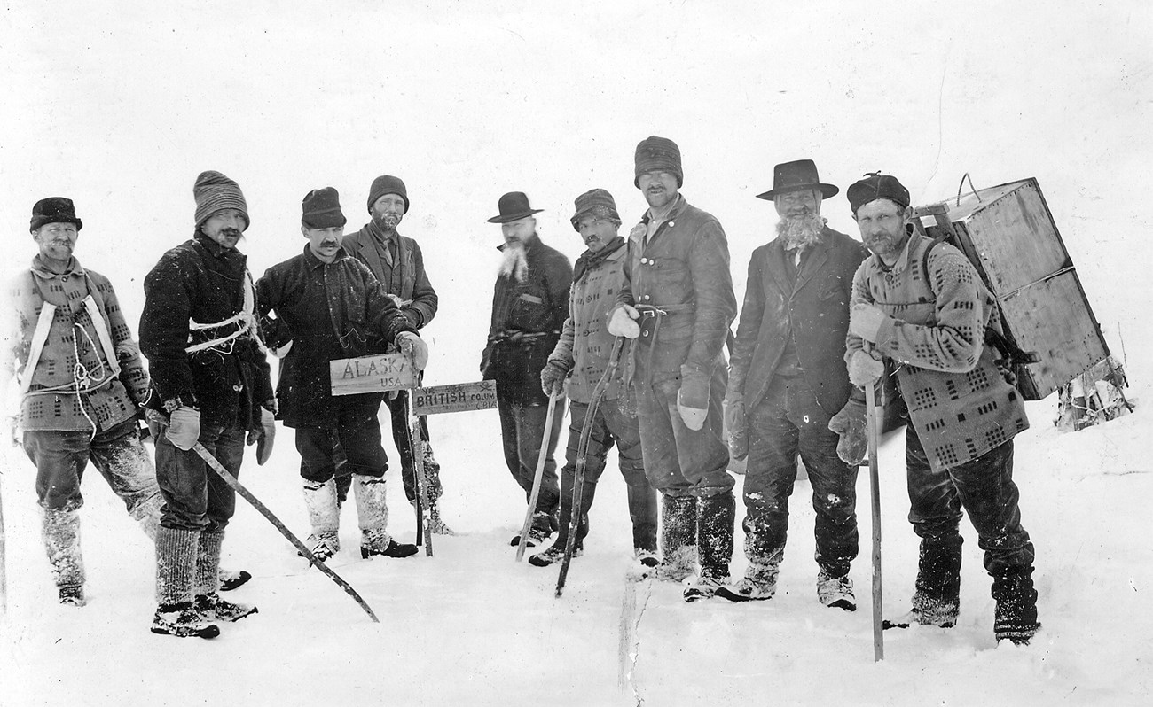 Gold-seekers enter Canadian territory at the summit of the 3,500-foot Chilkoot Pass, ca. 1895