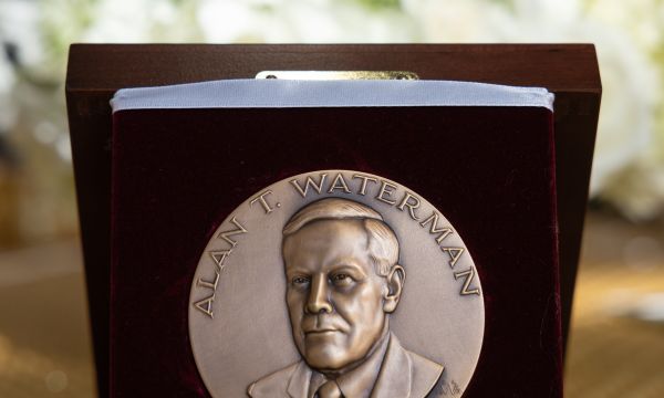 A circular medal in a display box. The medal contains the words "Alan T. Waterman Award" and includes the bust of Waterman.