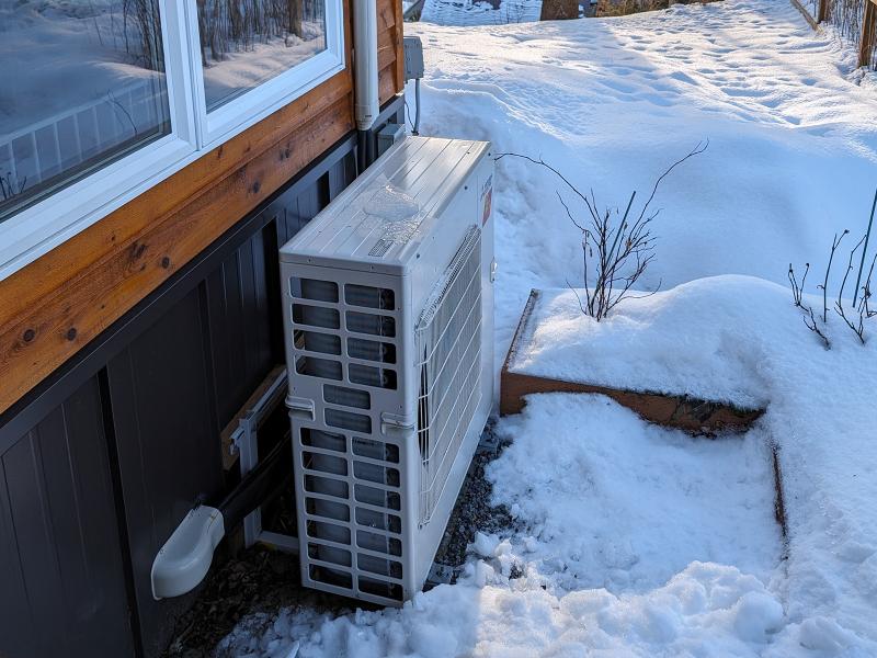 Cold climate heat pump alongside home