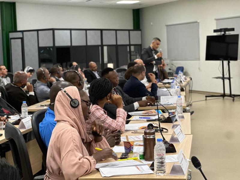 People inside a room, wearing headphones, at Saharan Fox Workshop.