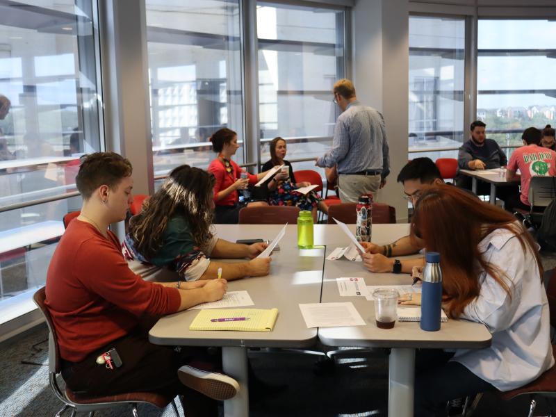 Students working together at a table. 