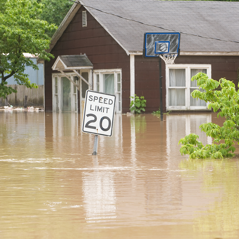 road around a house completely flooded