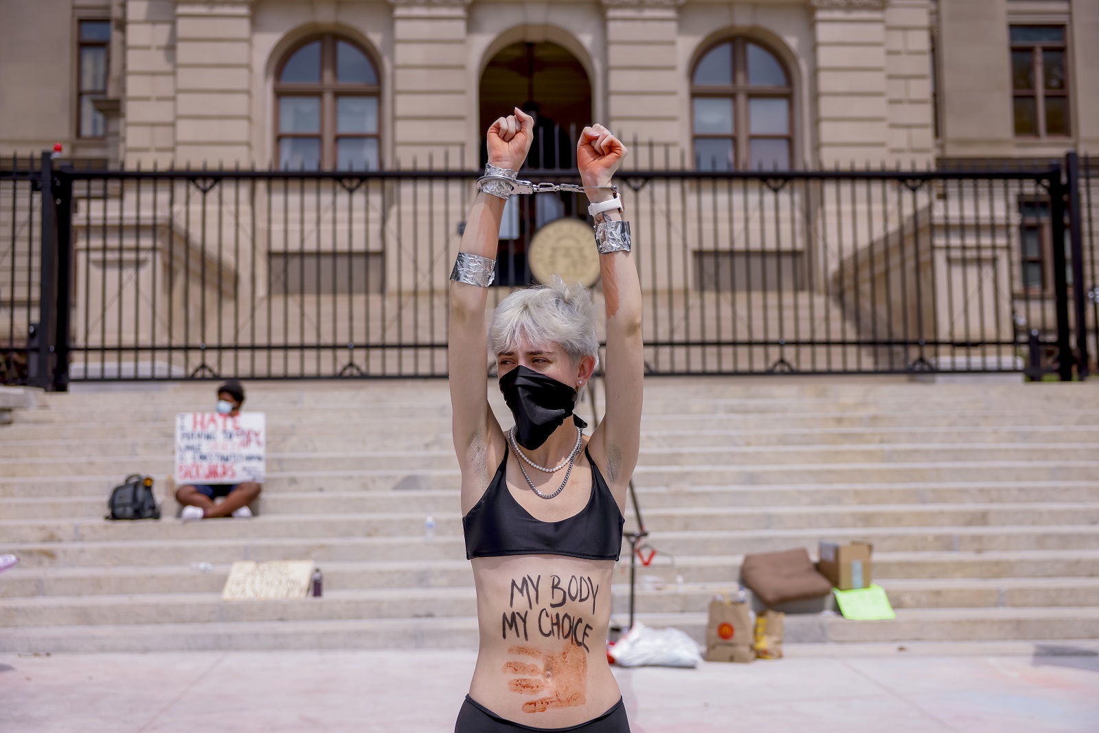 epa10038931 A woman joins a small group of pro-abortion demonstrators continue to protest outside the Georgia State Capitol after the US Supreme Court’s decision on the Dobbs v Jackson Women's Health Organization ruling in Atlanta, Georgia, USA, 28 June 2022. The court’s ruling overturned the legalization of abortion in the Roe v Wade case of 1973. Georgia’s 'Heartbeat' bill signed in 2019 has been blocked from taking effect due to a lawsuit being heard by the US 11th Circuit Court of Appeals.  EPA/ERIK S. LESSER