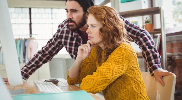 Man and woman looking at computer while discussing in office,Image: 260440274, License: Royalty-free, Restrictions: , Model Release: yes, Credit line: - / Wavebreak / Profimedia