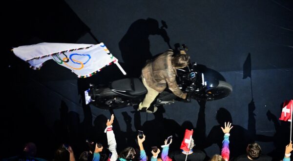 An overview shows US' actor Tom Cruise leaving the stadium with the Olympic flag on a motorbike during the closing ceremony of the Paris 2024 Olympic Games at the Stade de France, in Saint-Denis, in the outskirts of Paris, on August 11, 2024.,Image: 897884108, License: Rights-managed, Restrictions: , Model Release: no, Credit line: Julie SEBADELHA / AFP / Profimedia