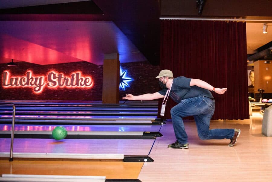 A masked man bowling