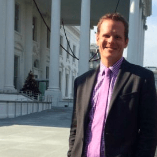 Story author, Christopher Poulos, standing in front of the White House