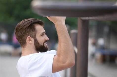 Premium Photo | Handsome young man exercising outdoors