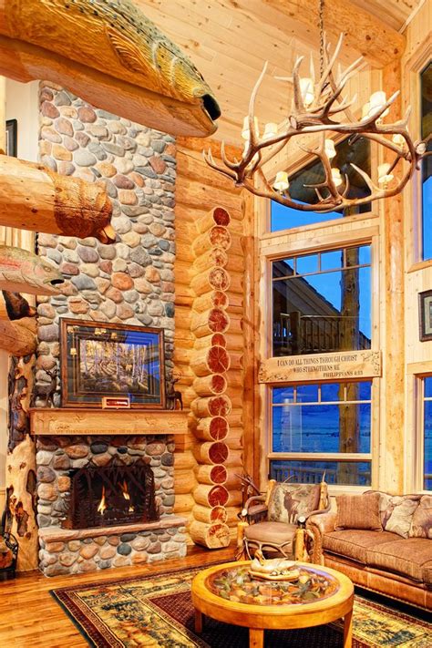 Photo of stone fireplace and living room inside a log home Home ...