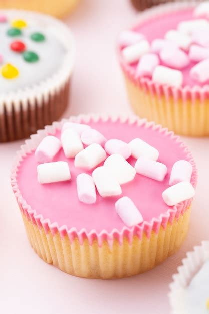 Premium Photo | Colorful cupcakes on a pink.