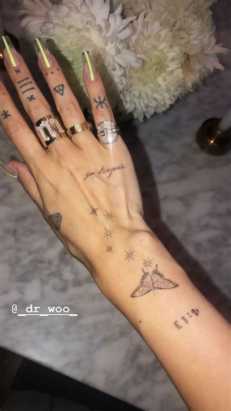 a woman's hand with some tattoos on it