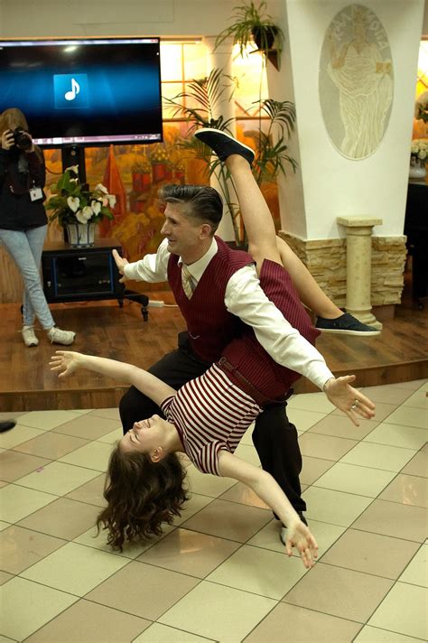 a man and woman are dancing on the floor