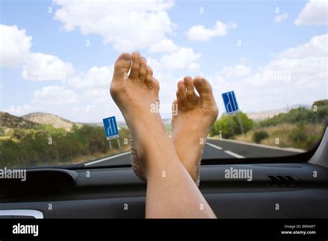 Feet resting on car dashboard Stock Photo: 31487659 - Alamy