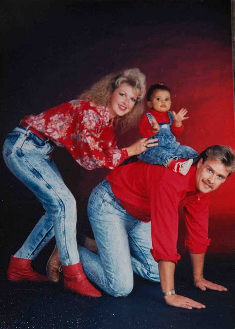 an old photo of three people posing for a picture with a doll on their lap