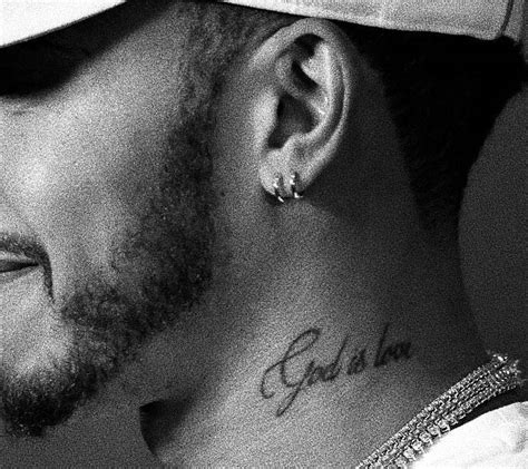 “God is love” tattoo on Lewis Hamilton's left side