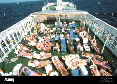 Cruise ship passengers use upper deck for sunbathing Stock Photo - Alamy