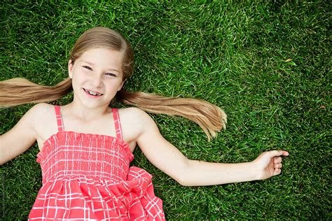 "Grass: Cute Young Girl Lying Back On Grass" by Stocksy Contributor ...