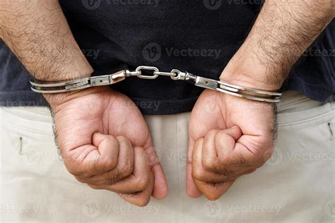 Prisoner male criminal standing in handcuffs with hands behind back ...