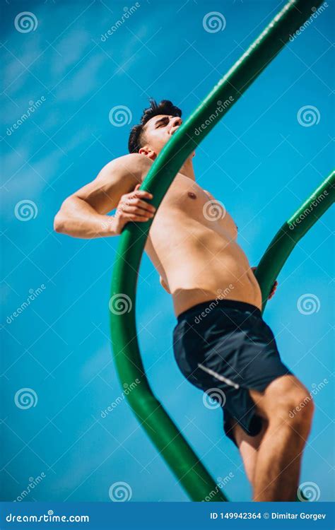 Guy Exercising Arms Doing Hard Exercises on Metal Bars Stock Photo ...