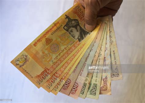 Bhutanese ngultrum banknotes of various denominations are arranged ...