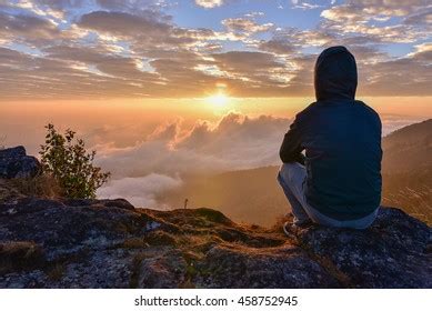 Man Sitting On Mountain Watching Sunrise Stock Photo 458752945 ...