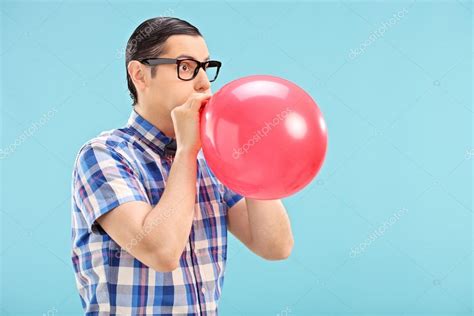 Man blowing up balloon Stock Photo by ©ljsphotography 48315683