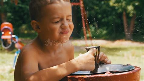 Boy Drinking at Water Fountain Stock Image - Image of water, drink: 8926171