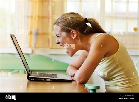 Woman gets angry about computer Stock Photo - Alamy