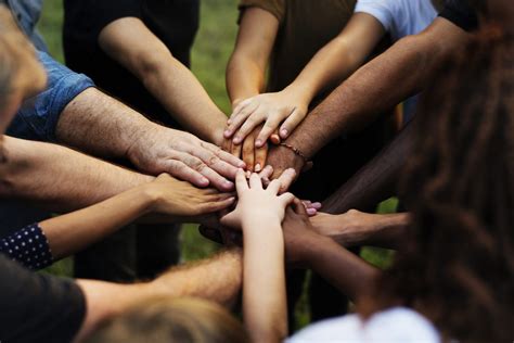 Group of people with their hands together – Circle of Care