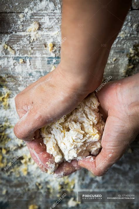 Above of hands kneading dough over rural wooden table — crop, recipe ...