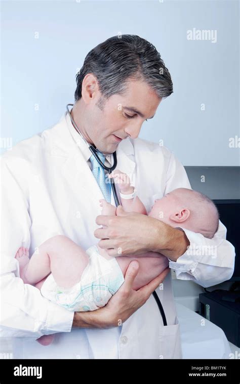 Doctor carrying a newborn baby Stock Photo - Alamy