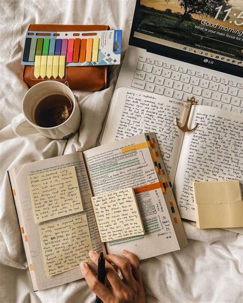 an open book with writing on it next to a laptop and cup of coffee in ...