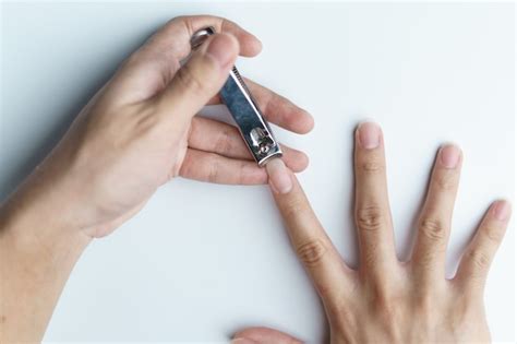 Premium Photo | Man using nail clipper clipping her fingernails