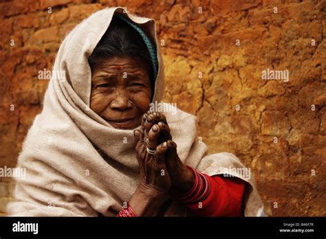 Portrait of old Nepali lady doing the Namasté hand gesture ...